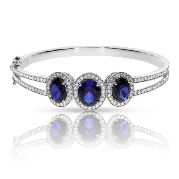 Experience cosmic elegance with the Celestial Tranquility gold bangle. Featuring mesmerizing oval sapphires and round-cut diamonds, it's perfect for milestone celebrations or as a meaningful gift for the peace bringer in your life.