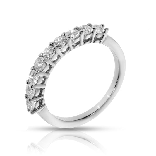 Discover the 'Eternal Cosmos' Gold eternity ring, featuring round-cut diamonds set like stars in the night sky. Symbolize eternal love and milestones.