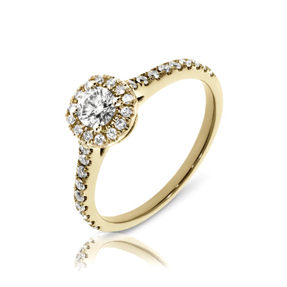 Enchanting gold halo ring with a round-cut diamond surrounded by a smaller diamond constellation. Available in 14K or 18K gold. Perfect for an anniversary or timeless love.
