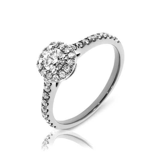 Enchanting gold halo ring with a round-cut diamond surrounded by a smaller diamond constellation. Available in 14K or 18K gold. Perfect for an anniversary or timeless love.