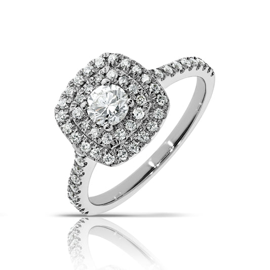 Capture the ethereal beauty of the cosmos with the "Celestial Radiance" halo ring. Crafted in gleaming gold, this exquisite piece features a stunning round-cut diamond at its heart, encircled by a halo that magnifies its brilliance, much like stars twinkling in the vast night sky. The gold setting adds modern elegance, perfect for symbolizing everlasting love or celebrating life's precious moments. Pairs beautifully with our "Celeste" earrings for a complete celestial ensemble.