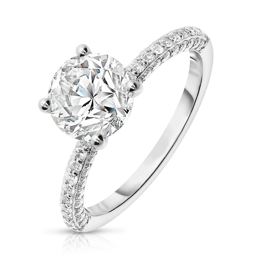 Experience the celestial beauty with the “Celestial Whisper” Gold sidestone ring. Featuring a luminous round-cut diamond and shimmering sidestones, it embodies the serene night sky. Perfect for celebrating love or personal milestones.