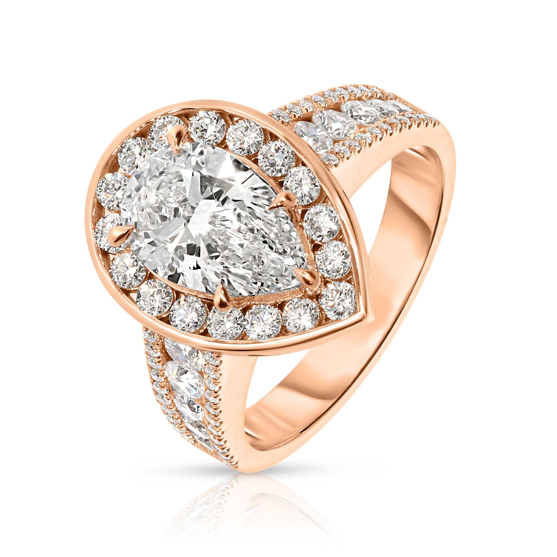 Experience the mystical elegance of the night sky with the "Tear of the Moon" Gold ring. This exquisite halo ring showcases a captivating pear-cut diamond at its heart, symbolizing the rare beauty of a moonlit tear. Encircled by a halo of shimmering diamonds, each stone glistens like stars against the Gold setting, evoking a celestial radiance that enchants and mesmerizes.