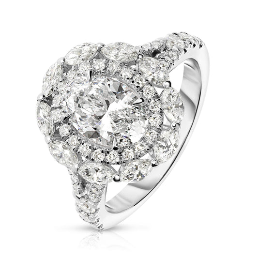 Embodying the ethereal beauty of the cosmos, the "Heaven's Embrace" Gold halo ring showcases an exquisite oval diamond, capturing celestial glow of a tranquil night sky. Encircled by a halo of shimmering round-cut diamonds, it's a symbol of eternal grace. Perfect for engagements, anniversaries, or self-adornment.