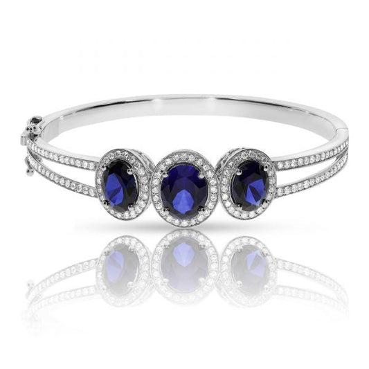Experience cosmic elegance with the Celestial Tranquility gold bangle. Featuring mesmerizing oval sapphires and round-cut diamonds, it's perfect for milestone celebrations or as a meaningful gift for the peace bringer in your life.